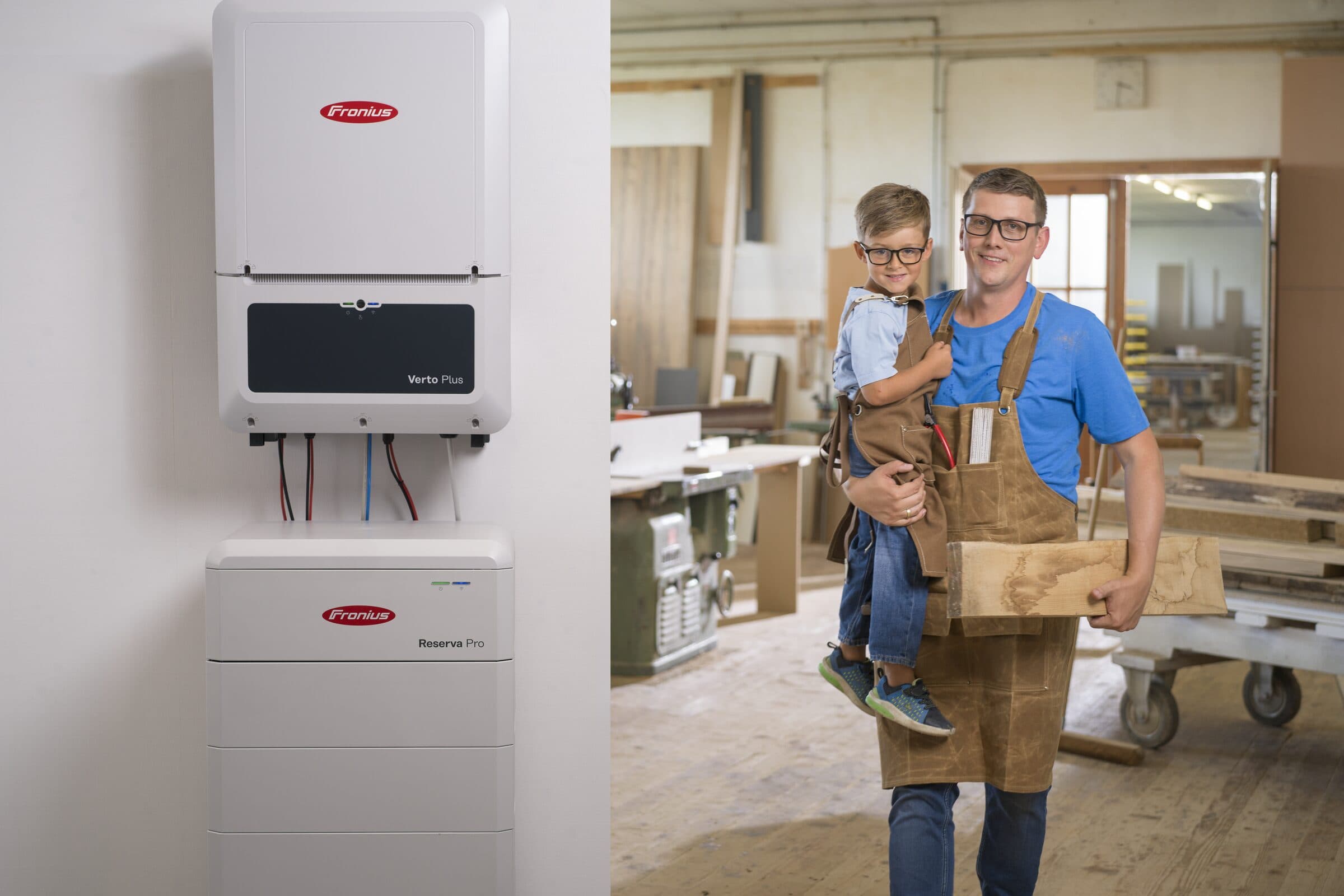 Fronius Verto Plus og Reserva Pro monteret på væggen i et værksted, hvor indehaveren står med sit barn på armen
